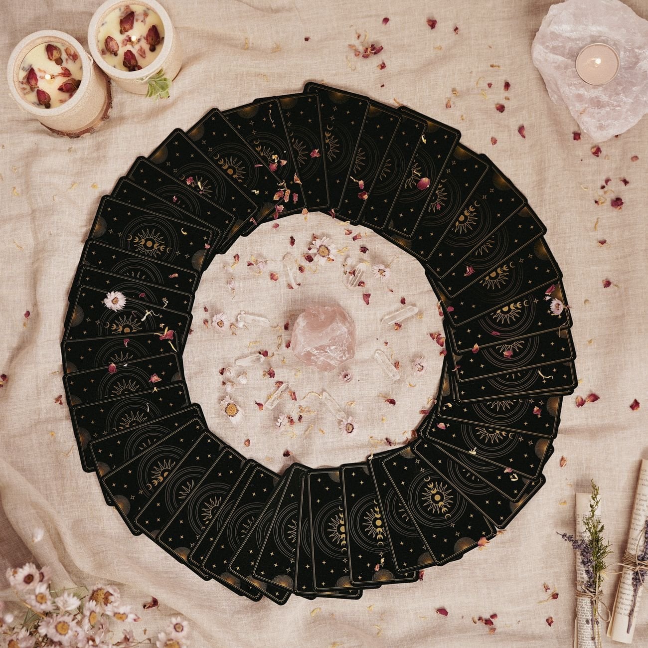 A circle of tarot cards with a crystal centerpiece on a floral-decorated cloth, creating a mystical ambiance.